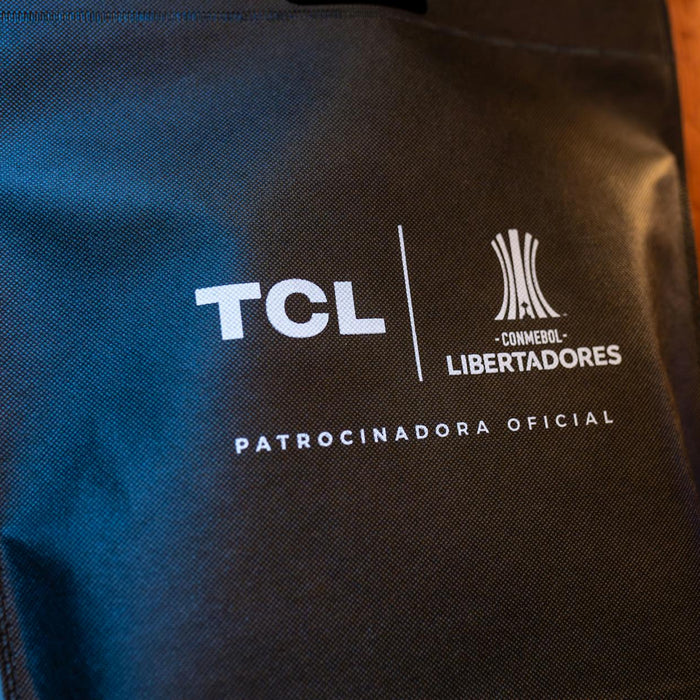 Close-up of a black sponsorship bag showing TCL and CONMEBOL Libertadores logos with brand details.