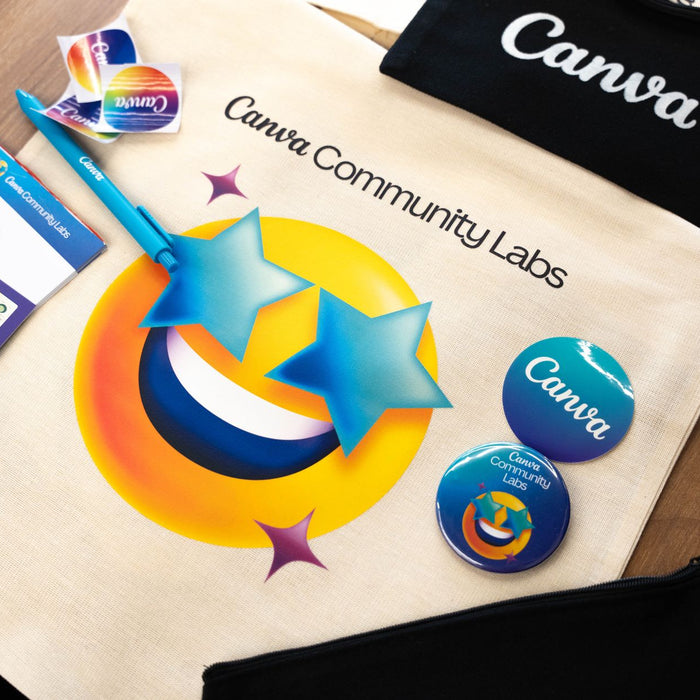 A vibrant display of Canva Community Labs tote, badges, and stationery.