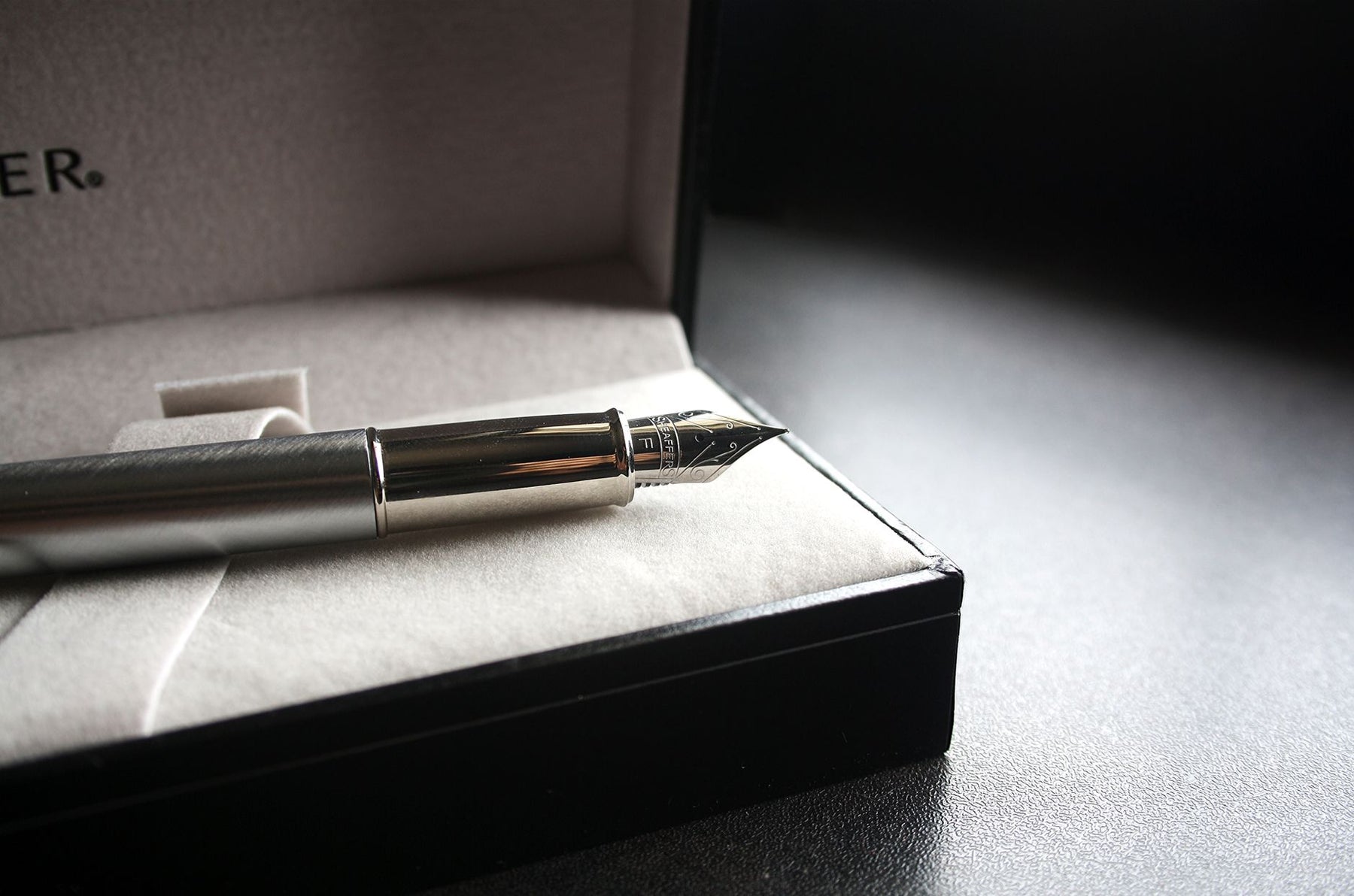 Close-up of a luxury fountain pen in a velvet-lined box, perfect for gifting.
