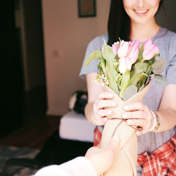 woman holding flower bouquets