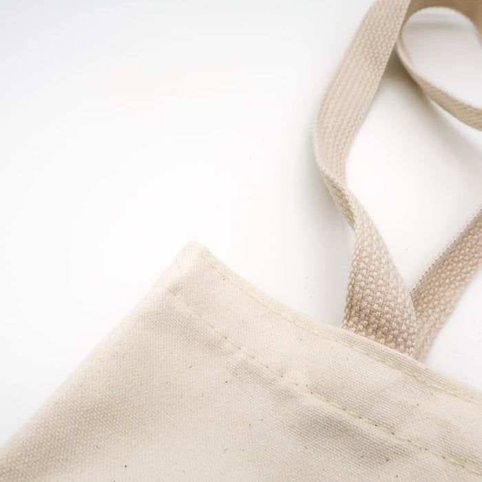 brown tote bag on white surface