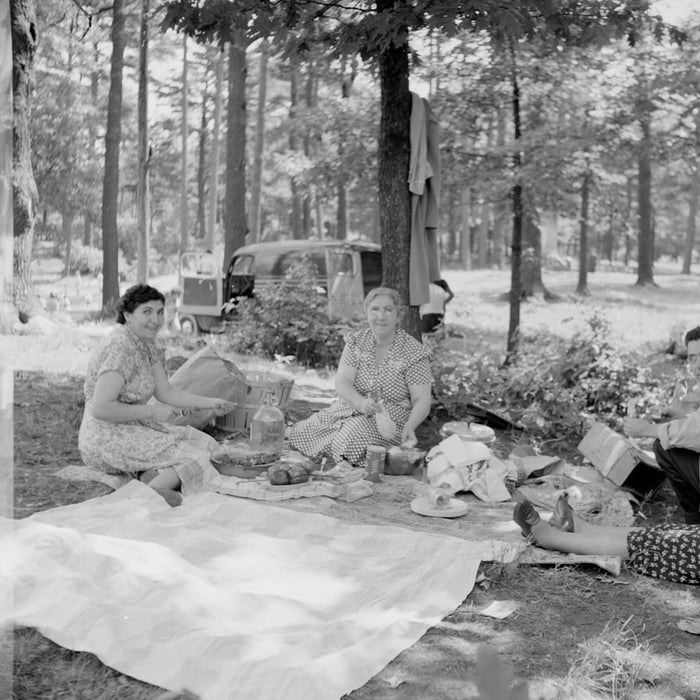 grayscale photo of people sitting on ground