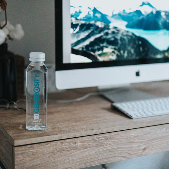 clear plastic bottle beside silver imac