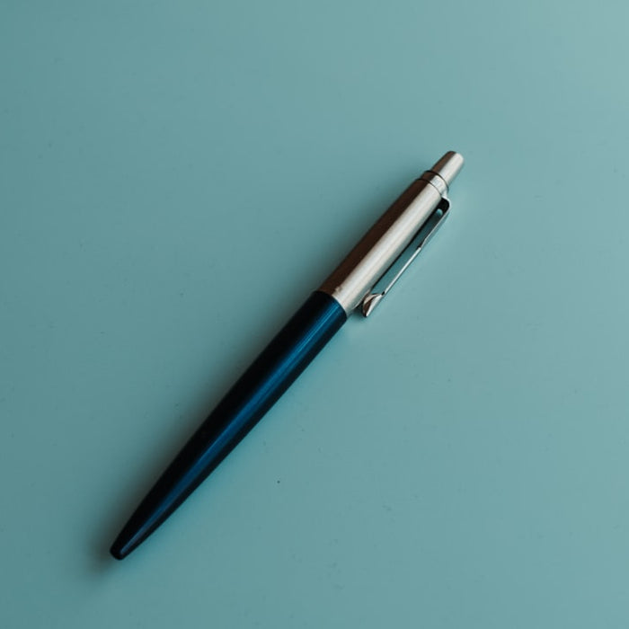 silver and blue click pen