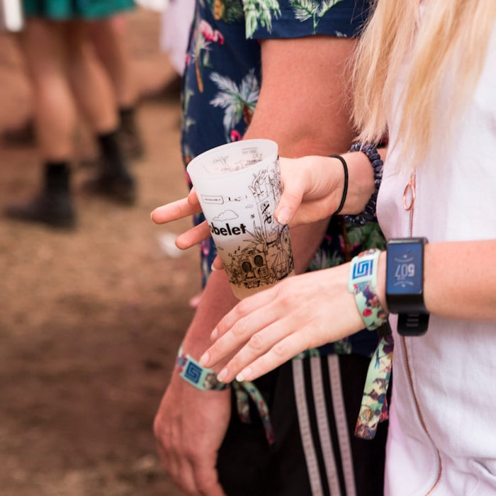 woman in white long sleeve shirt holding starbucks cup