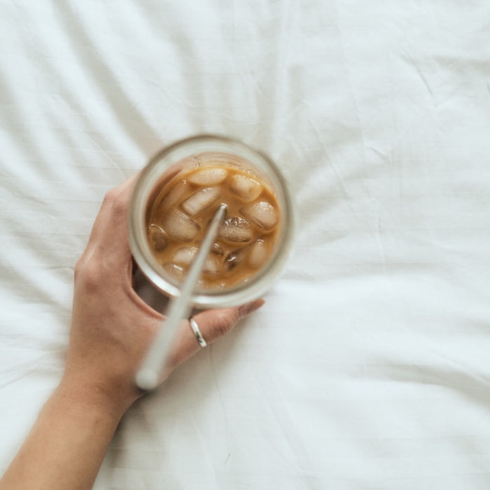 person holding white ceramic mug with coffee