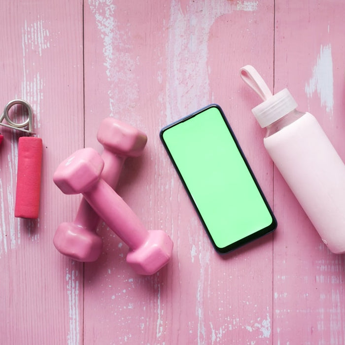 person holding pink and white plastic bottle