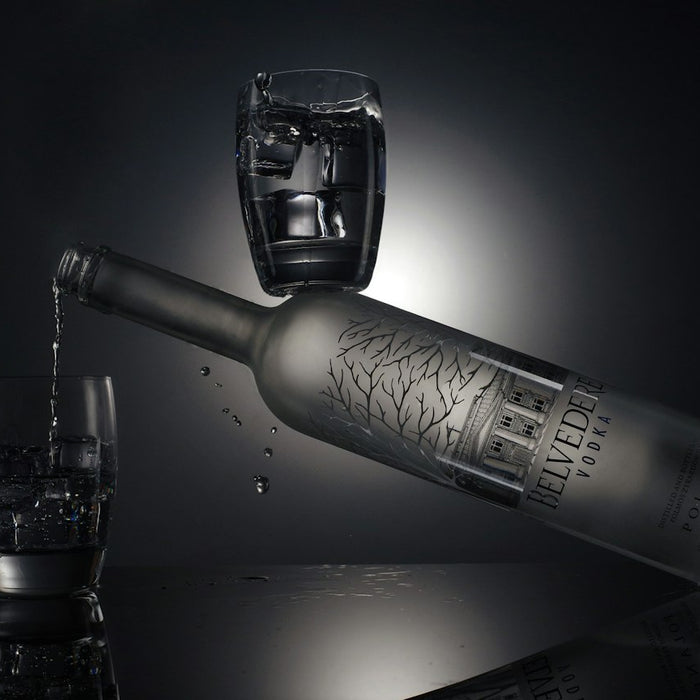 clear drinking glass beside silver bottle