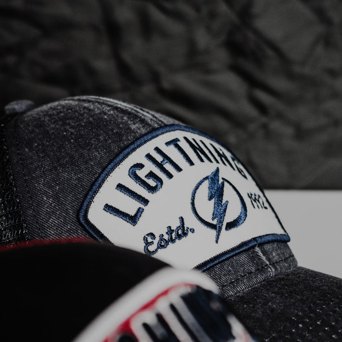 a baseball cap with a lightning patch on it
