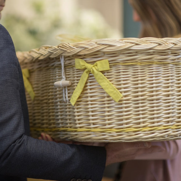 a man in a suit holding a wicker basket