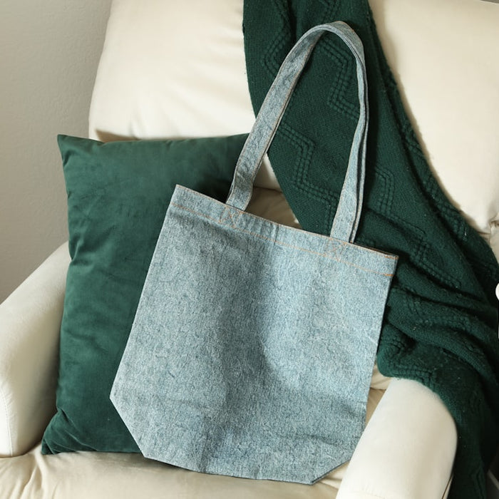 a blue bag sitting on top of a white chair