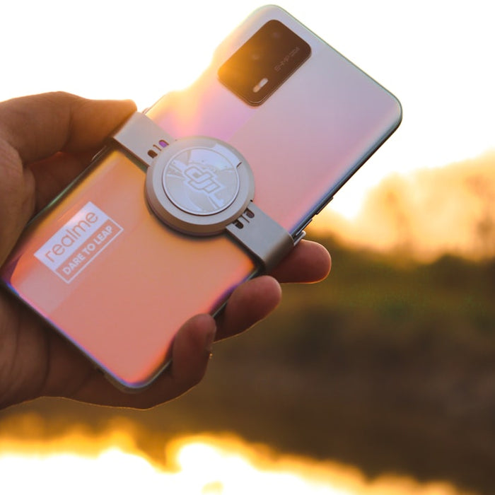 a person holding a cell phone in their hand
