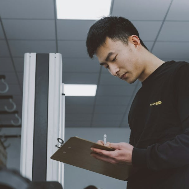 a man standing in a room holding a clipboard