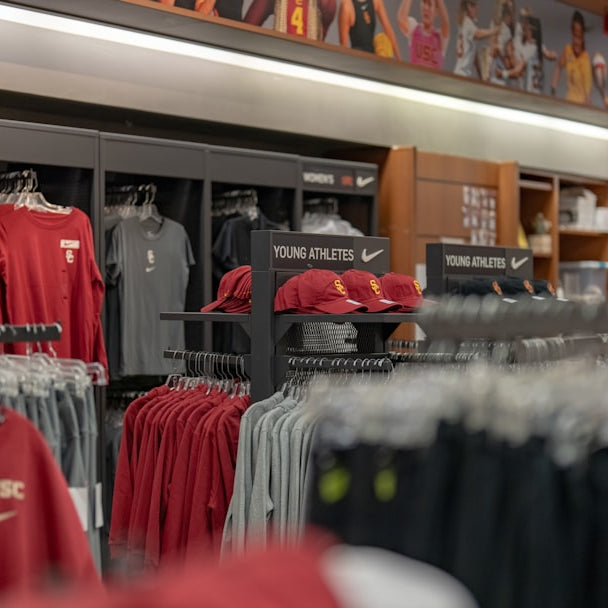 a store filled with lots of red and black shirts