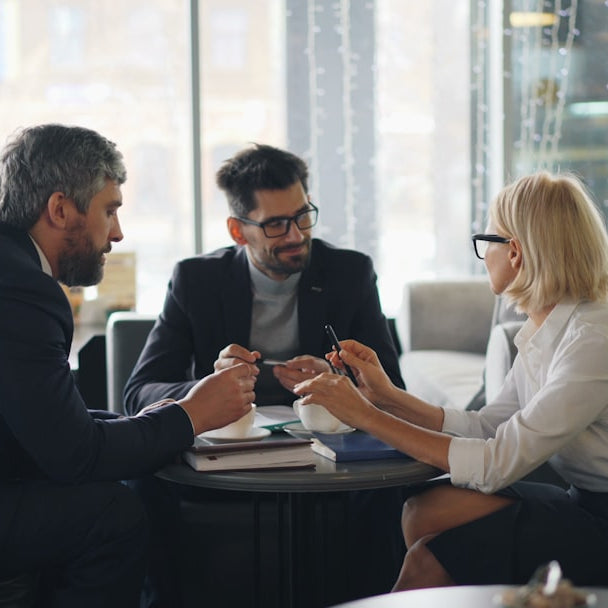 a group of people sitting around a table