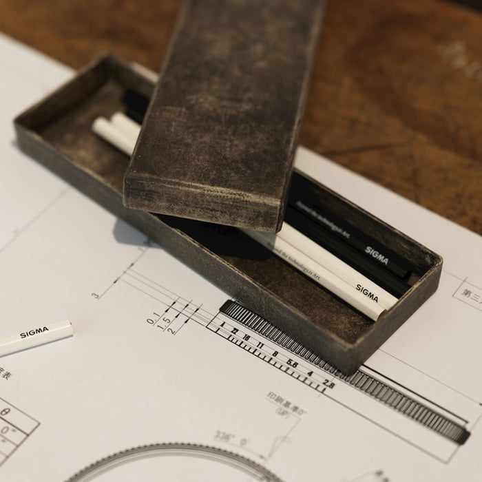 A pencil and ruler sitting on top of a piece of paper