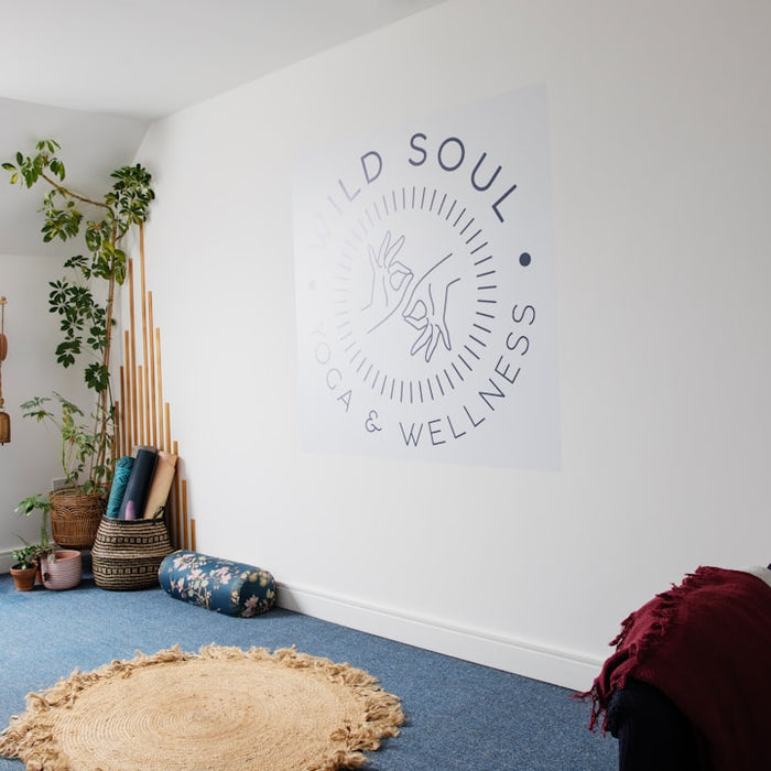 A room with a blue carpet and a white wall