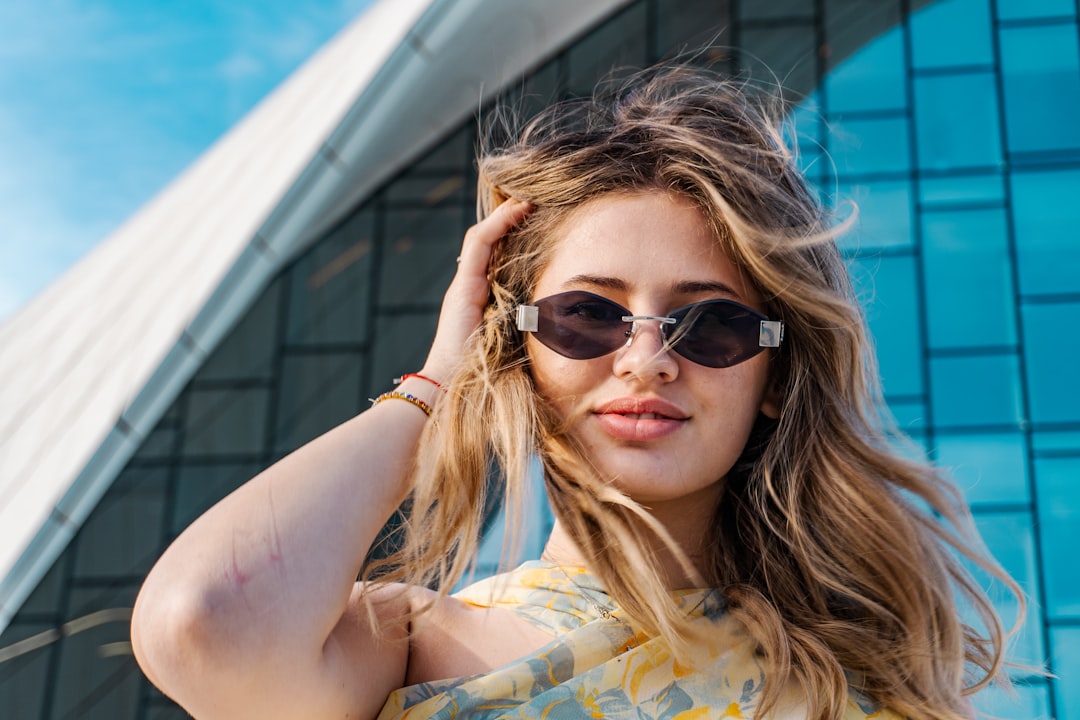 Young woman with sunglasses in front of modern building