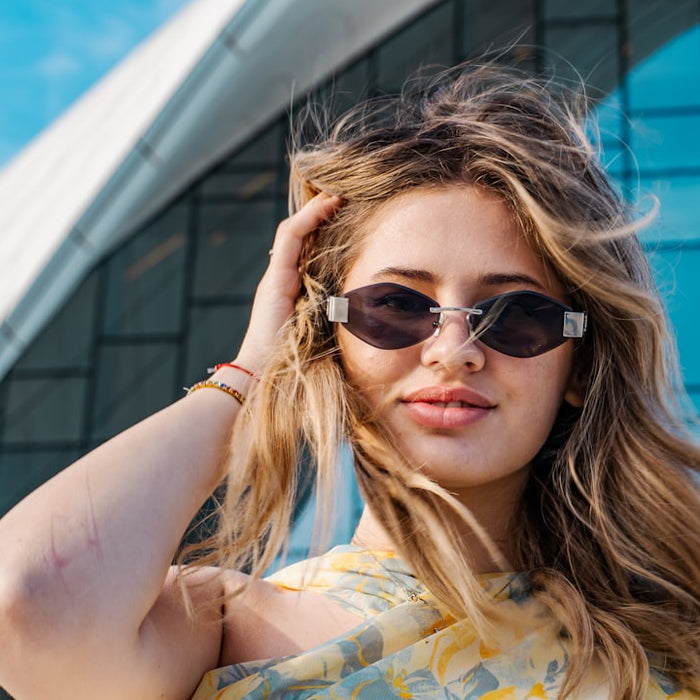 Young woman with sunglasses in front of modern building