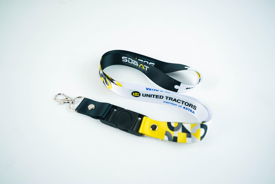 Two lanyards with united tractors logo on white background