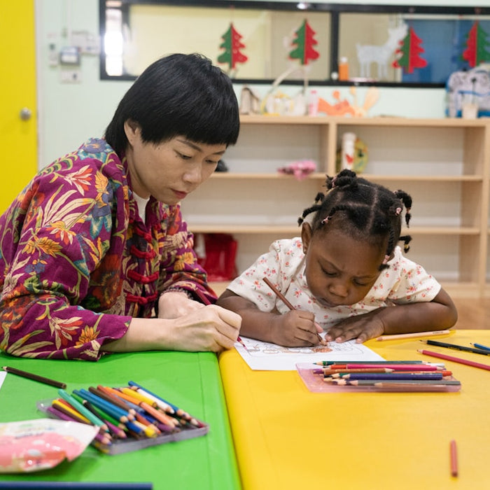 Adult and child drawing together at a table