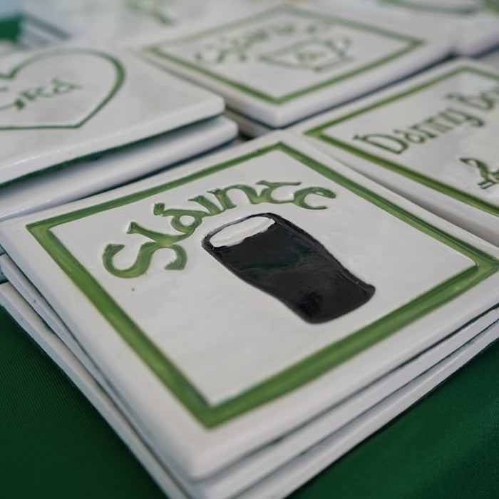 Stack of irish themed coasters with green designs