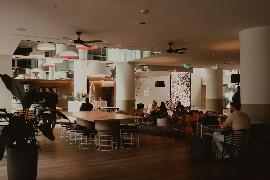 People relaxing in a modern, spacious hotel lobby lounge area