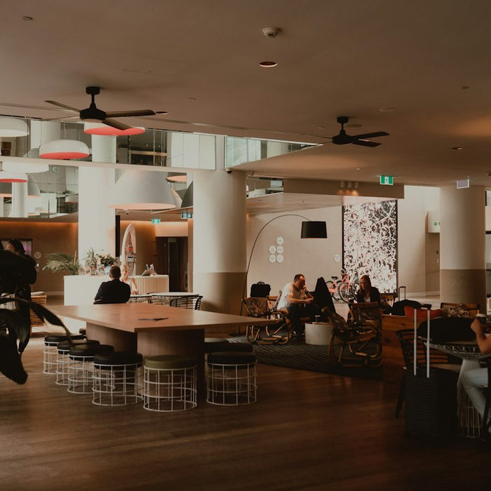 People relaxing in a modern, spacious hotel lobby lounge area