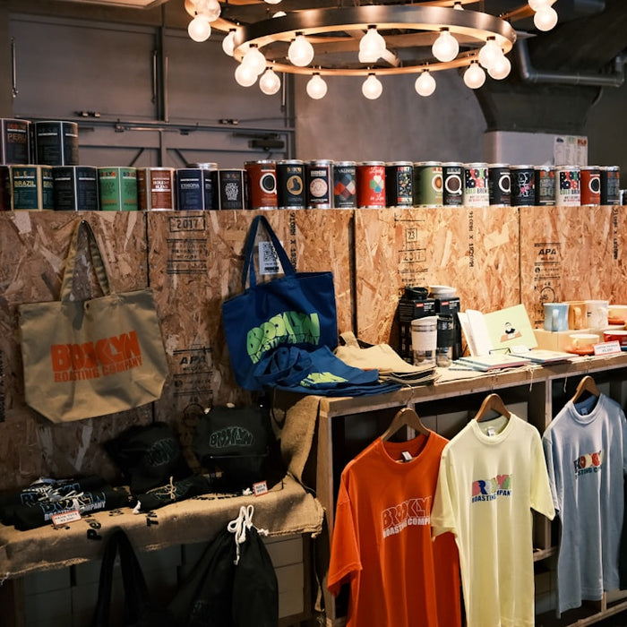 Shop interior featuring apparel, accessories, and cans on wooden displays