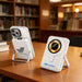 10000mAh Magnetic Wireless  Power Bank with Phone Stand - A white magnetic wireless power bank with a phone stand, positioned on a wooden table in a library setting.