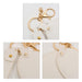 Heart-Shaped Compact Mirror with Keychain - A heart-shaped compact mirror in white with a keychain attachment and gold accents. Features a clasp and loop.