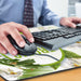 Jumbo Desk Mat - A hand using a black mouse on a floral-printed desk mat, with a keyboard visible in the background.