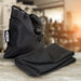 RPET Cooling Towel - A black RPET cooling towel neatly folded next to a matching drawstring bag, featuring a logo.