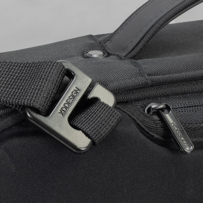 Bobby Bizz Anti-theft Backpack  Briefcase - A close-up of a black anti-theft backpack featuring a sturdy buckle and zipper detail. It has a sleek, modern design.