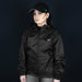 Swiss Peak Urban Windbreaker - A black windbreaker jacket with a hood, featuring a front zipper and side pockets, worn by a model.