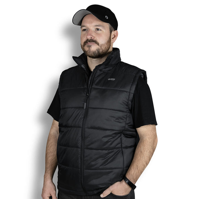 Swiss Peak Urban Puffer Vest - A man wearing a black puffer vest, featuring a zip front and a collar, with a logo on the upper left.
