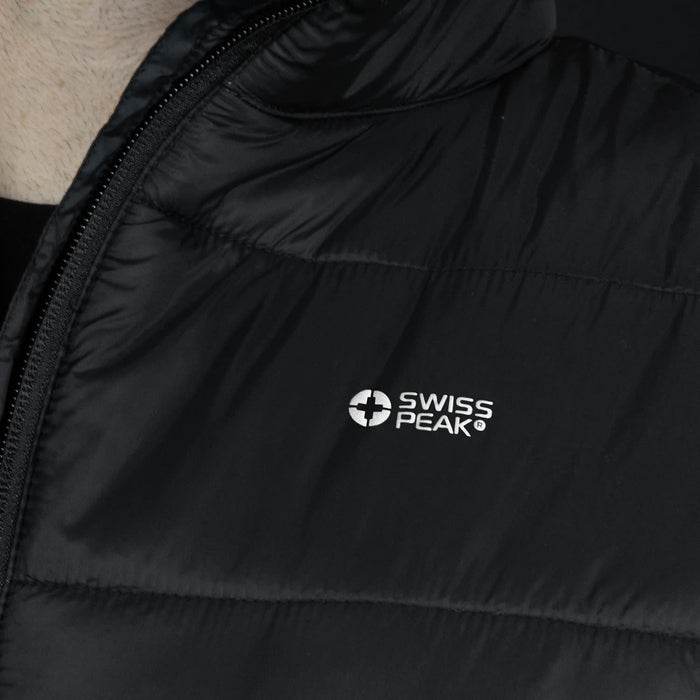 Swiss Peak Urban Puffer Vest - A close-up of a black puffer vest featuring a logo. The fabric appears smooth and insulated.