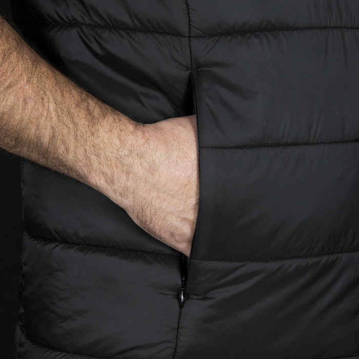 Swiss Peak Urban Puffer Vest - A black puffer vest featuring a side pocket, highlighting a hand placed inside the pocket.