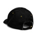 Essence Organic Cap - A black cap featuring a curved brim and gold eyelets, with an adjustable strap at the back.