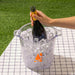 Alpine Ice Bucket - A clear ice bucket filled with ice, holding a bottle of sparkling wine, featuring an orange logo.