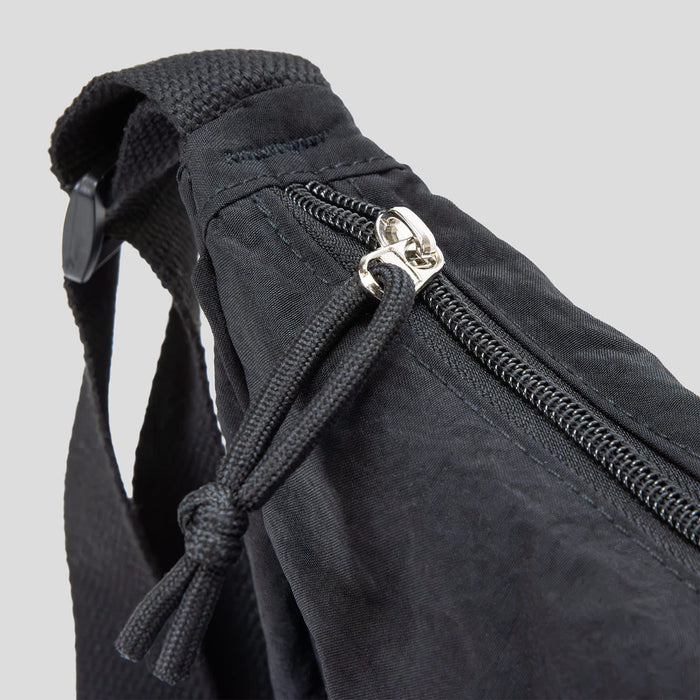 Selene Moon Bag - A black bag featuring a zip closure and adjustable strap, with a woven texture. It includes a logo on the side.