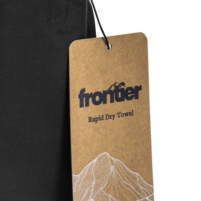Frontier Rapid Dry Towel - A black rapid dry towel with a tag featuring a logo and mountain design.