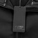 Swiss Peak Urban Unisex Softshell Jacket - A black softshell jacket with a branded tag attached near the collar. The fabric appears soft and warm.