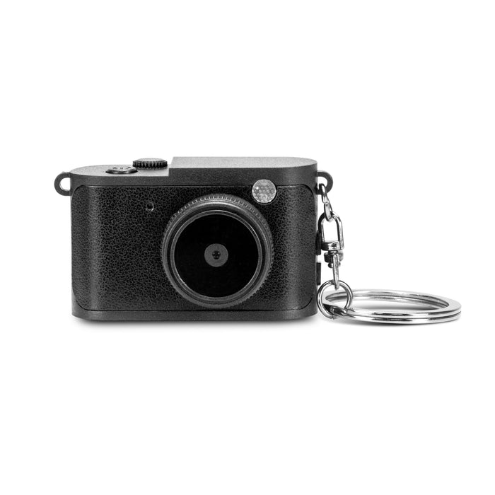 Candid Mini Camera - A mini camera in black with a textured finish and a keychain attachment. It features a round lens and a control dial.