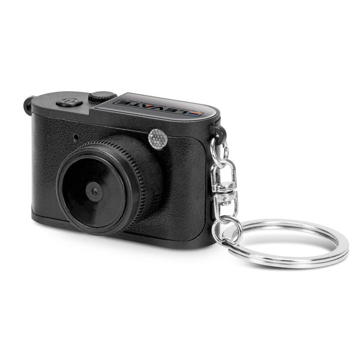 Candid Mini Camera - A small black camera keychain with a detailed lens and a keyring attachment. It has a logo on the top.