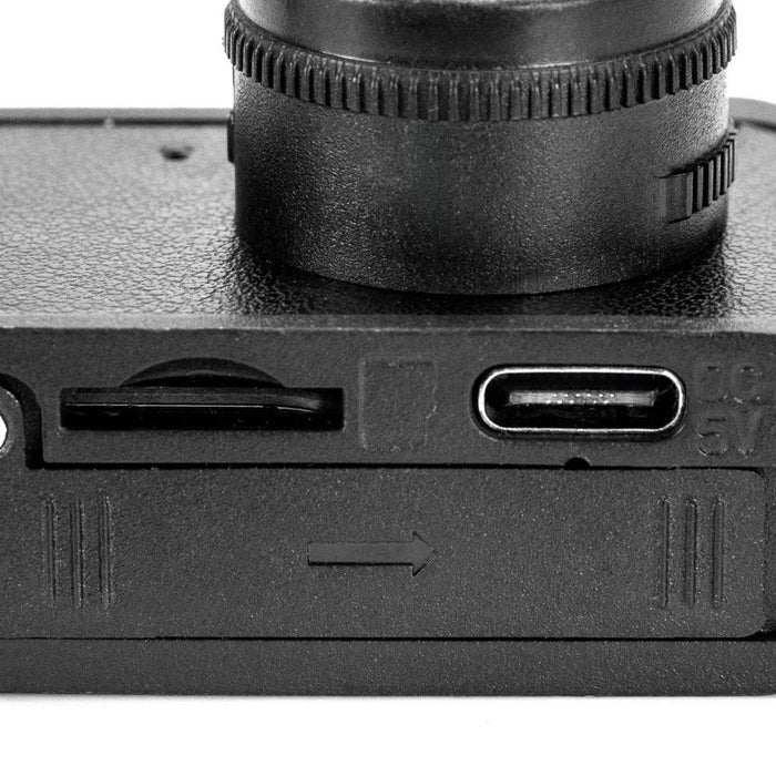 Candid Mini Camera - A black mini camera featuring a lens, USB-C port, and a memory card slot. It has a textured surface.