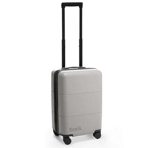 Kadi Carry-On Suitcase - Leisure - A grey carry-on suitcase with four wheels and a retractable handle, featuring branding on the side.