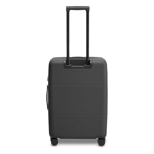 Kadi Check-In Suitcase - Medium - A medium-sized suitcase in matte black, featuring a retractable handle and wheels for easy mobility.