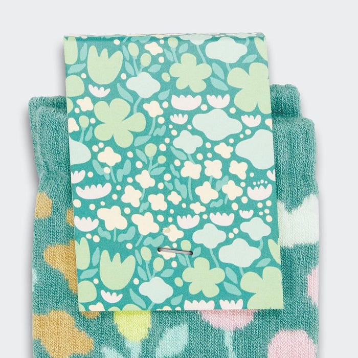 Jolly Knitted Bamboo Kids Socks - Knitted bamboo kids socks in teal with floral patterns, featuring a colourful card with a flower design.