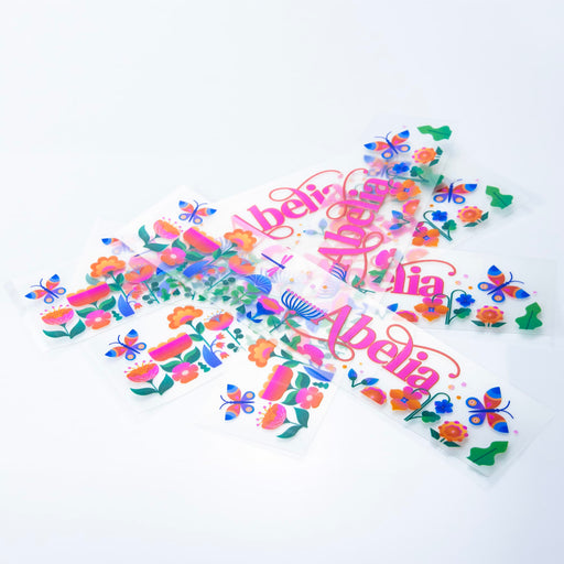 Prism Print - 250 x 50mm Sticker - A collection of colourful stickers featuring floral and butterfly designs, displayed against a white background.